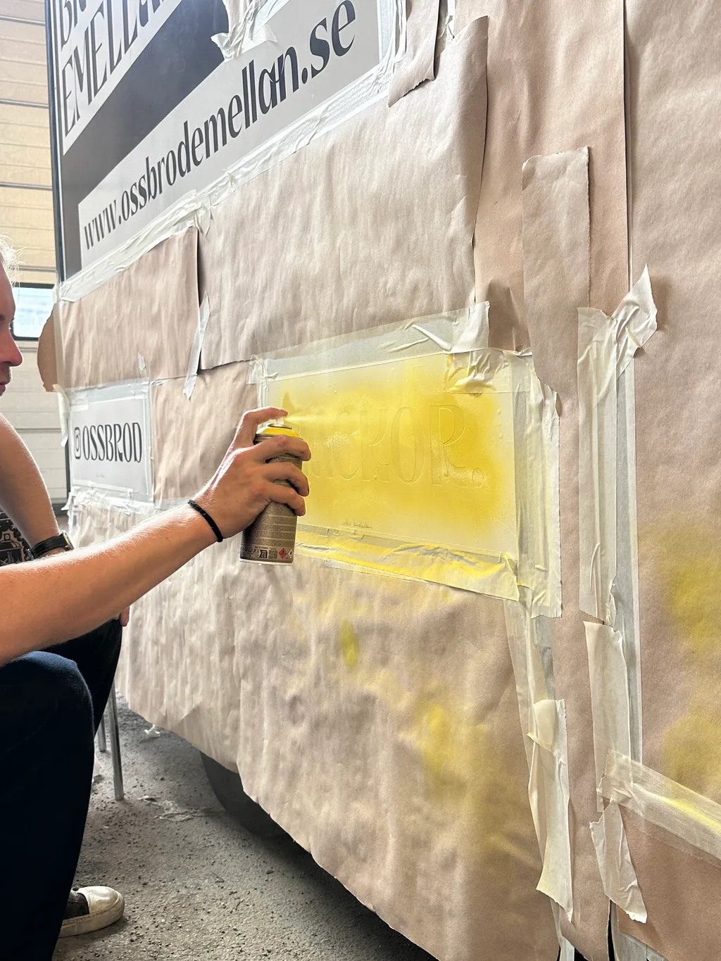 Foodtruckens foliering sprejas för hand genom en stencil